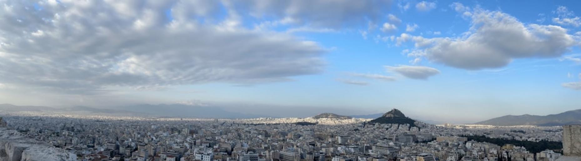 A panoramic view of Göbekli Tepe showing massive carved stone pillars and circular enclosures amidst rugged terrain